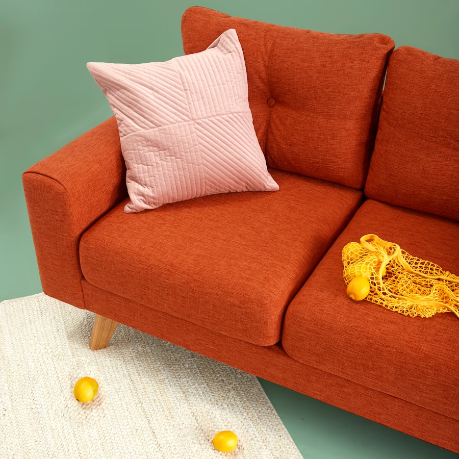 Terracotta throw pillows and ceramic vase on a cream sofa